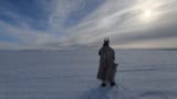 Artist Tom Bailey trekking in the Arctic with reindeer antlers