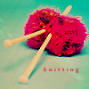 glinda: wooden needles in two bright red/pink balls of wool (knitting)
