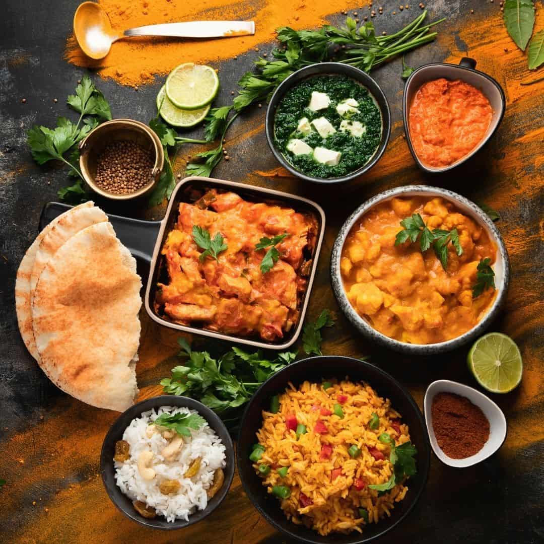 An image of various bowls filled with Indian fooc