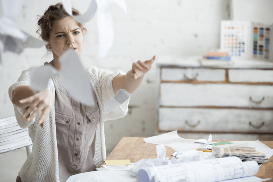 photo of woman in craft room throwing papers